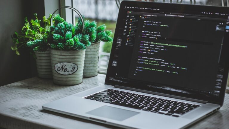 Computer on desk with code editor open
